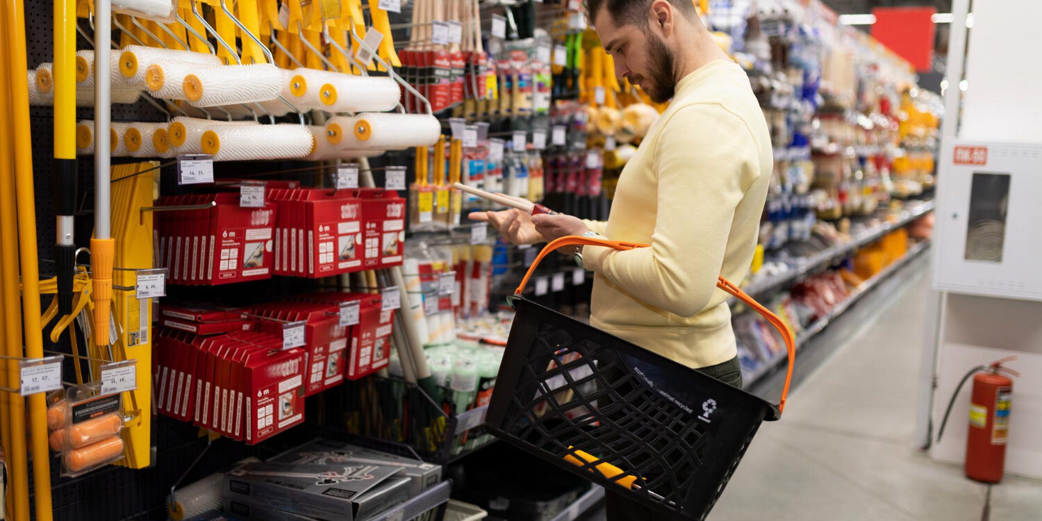 man-chooses-tool-painting-work-decorating-materials-store